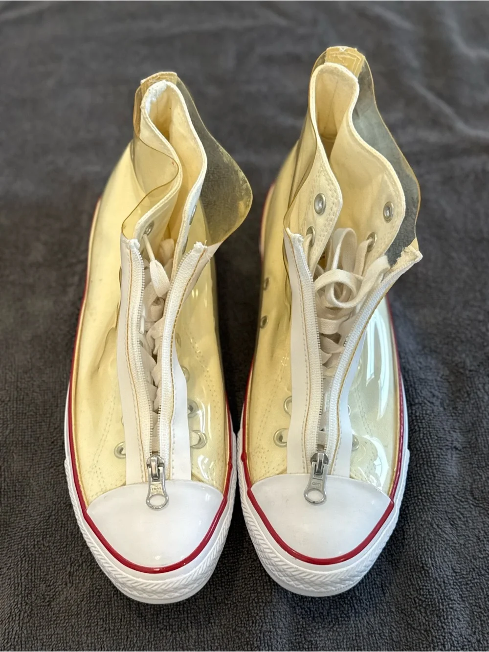 Converse white High Top Sneakers with vinyl zip cover.